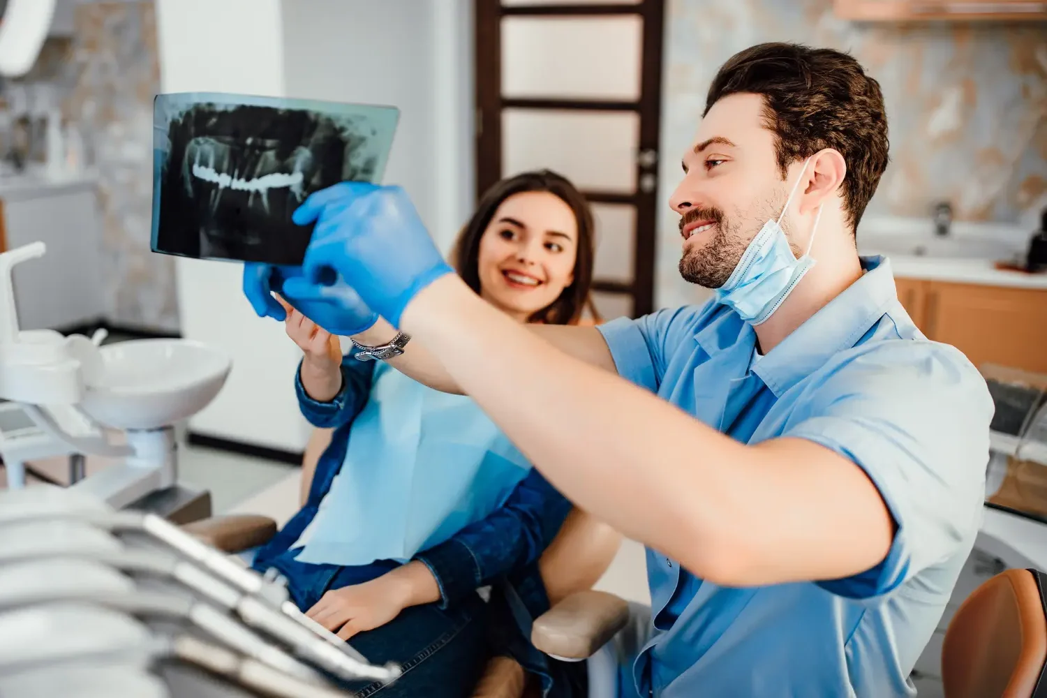 Dr. Pouria Owtad answering a patient's questions about dental implants in his Phoenix office