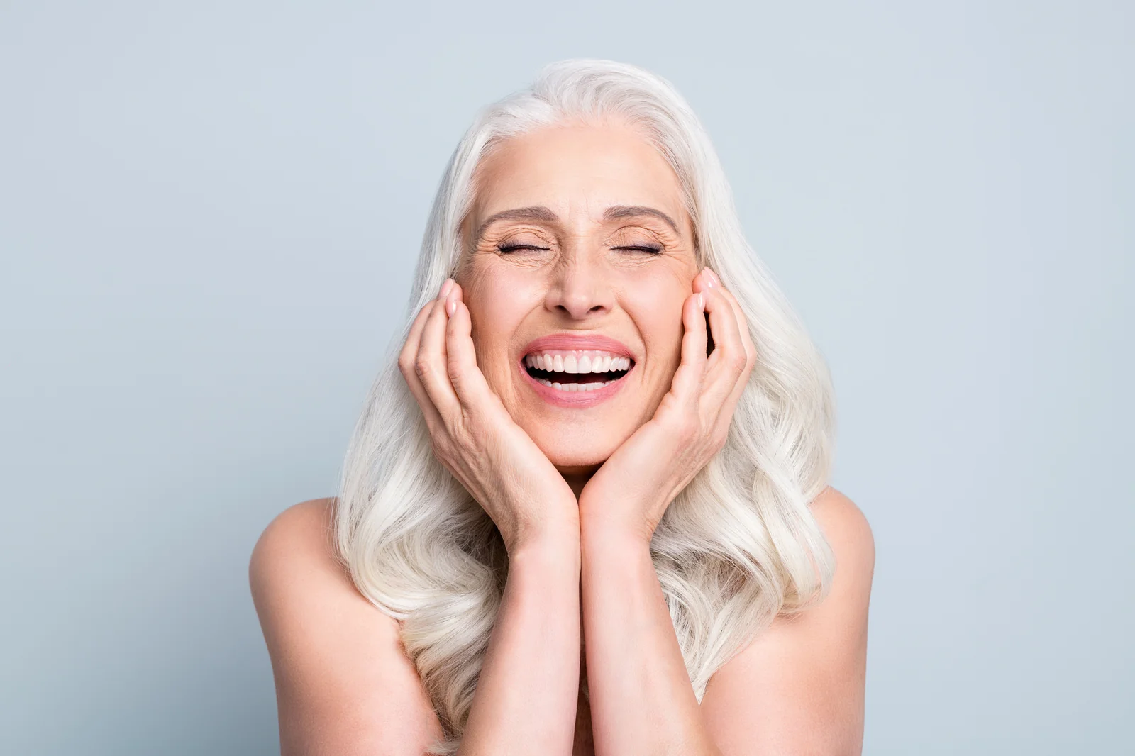 Confident mature woman smiling after dental implant treatment at Diamondback Dentistry in North Phoenix